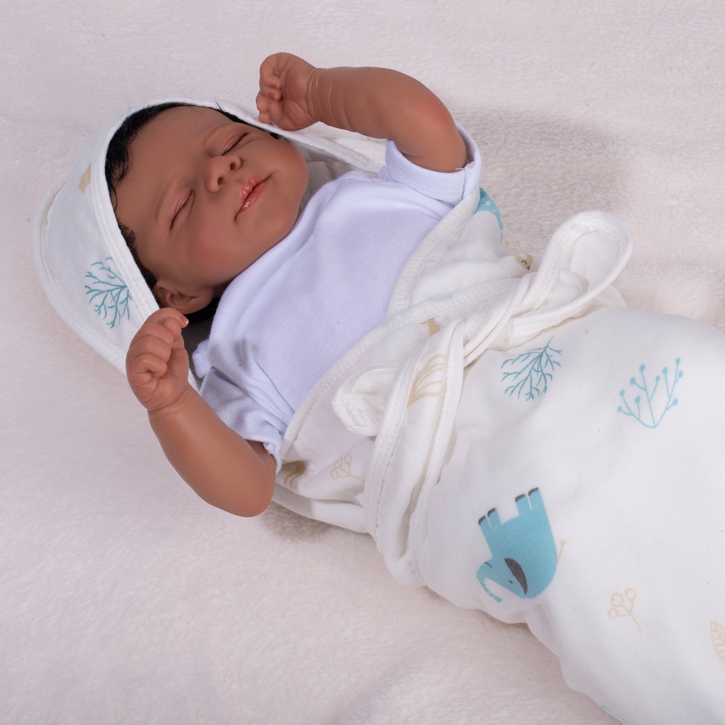 A newborn baby snugly wrapped in a breathable newborn receiving blanket with the attached hood on, preventing overheating for better sleep.