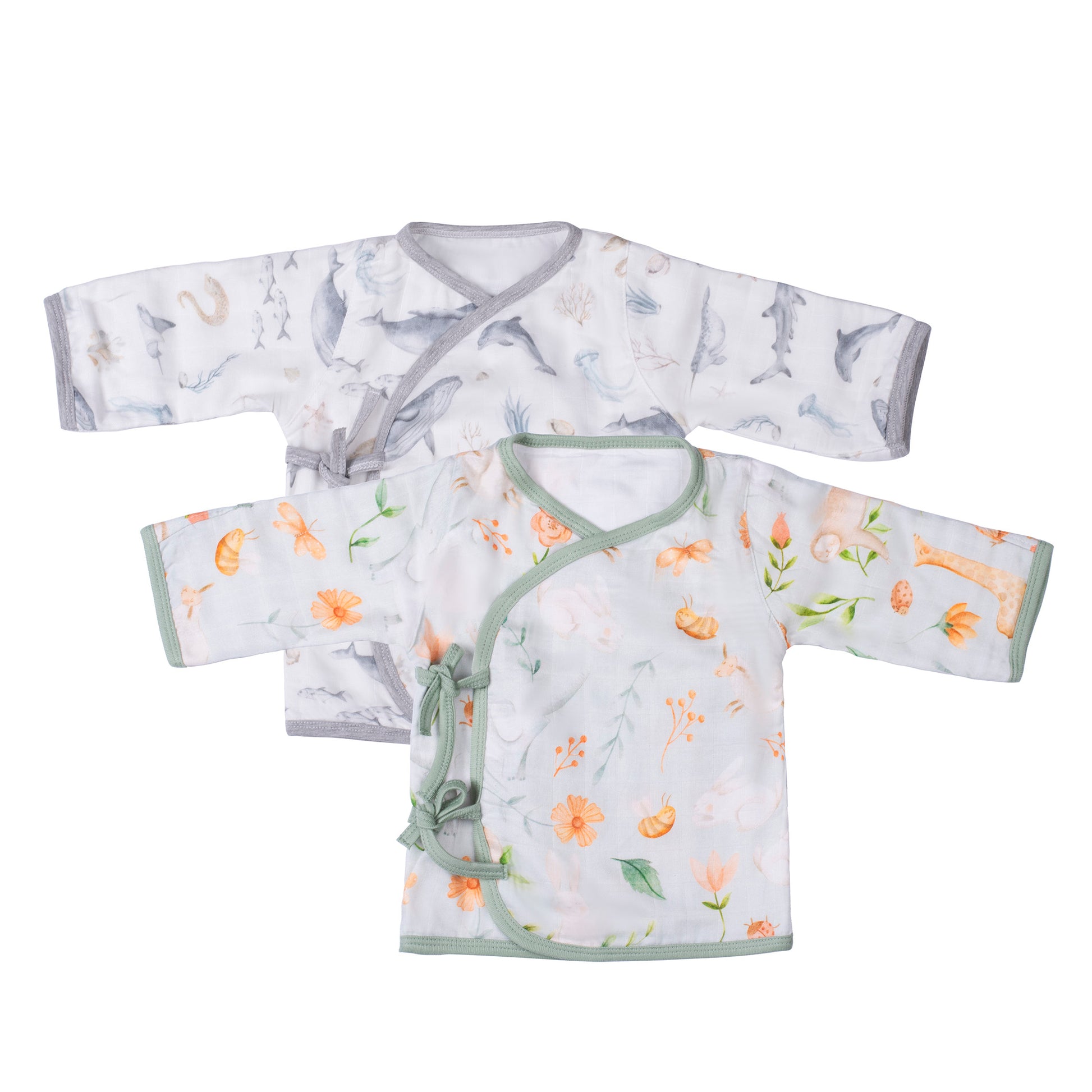 A pair of organic bamboo muslin newborn kimono style monk style tops, one with a gray ocean creature pattern and the other with a green plant and rabbit pattern, laid flat.